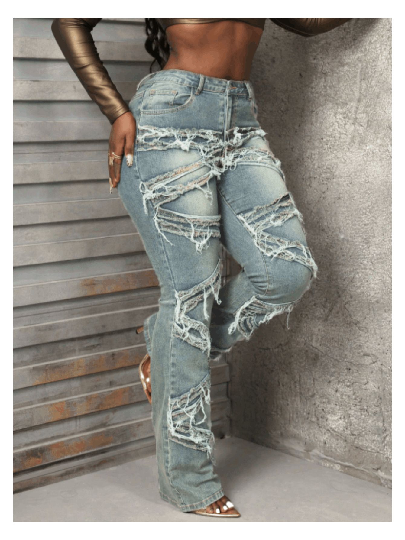 Vintage-style women's water-washed distressed pants with slit at the hem, made of denim fabric.